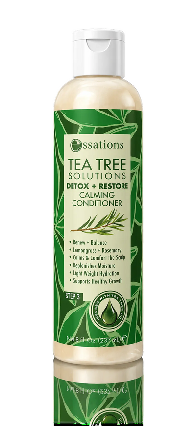 A bottle of Essations Tea Tree Solutions Detox + Restore Calming Conditioner, featuring a green and white label with a white cap, set against a solid black background with a reflection below.